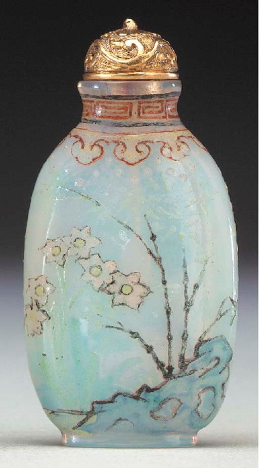 AN ENAMELED WHITE GLASS BOTTLE