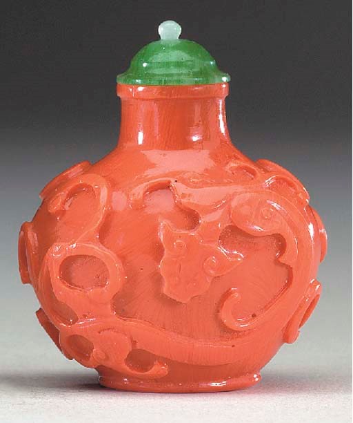 A CARVED 'IMITATION CORAL' GLASS BOTTLE