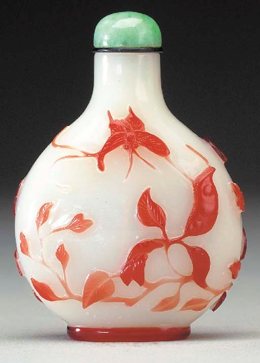 A RED OVERLAY WHITE GLASS BOTTLE