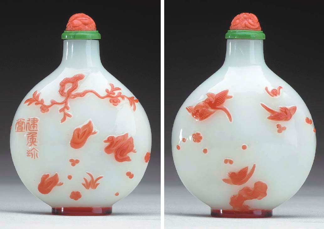 A RARE AND FINELY CARVED RED OVERLAY  WHITE GLASS BOTTLE