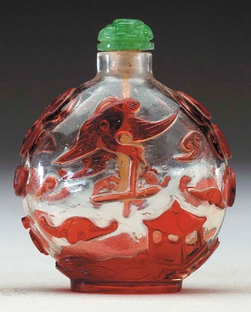 A RED OVERLAY CLEAR GLASS BOTTLE