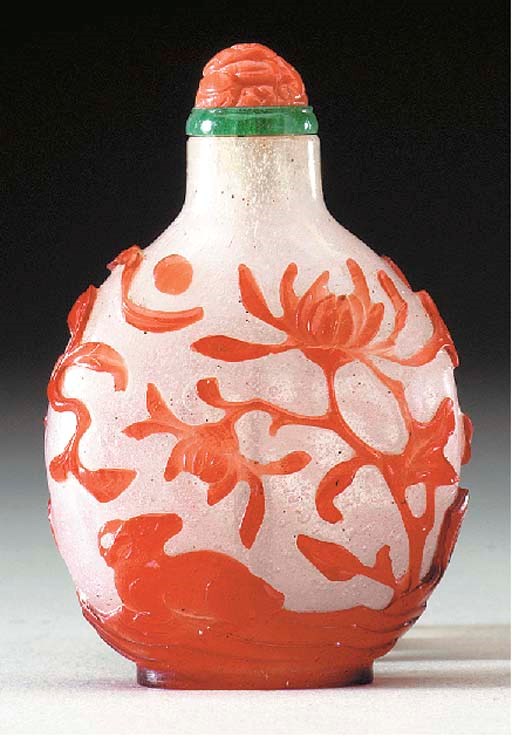 A RED OVERLAY 'SNOWSTORM' GLASS BOTTLE