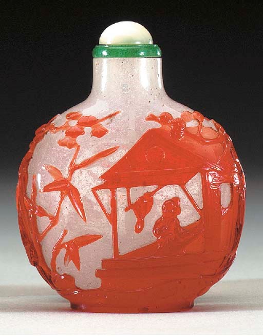 A RED OVERLAY 'SNOWSTORM' GLASS BOTTLE