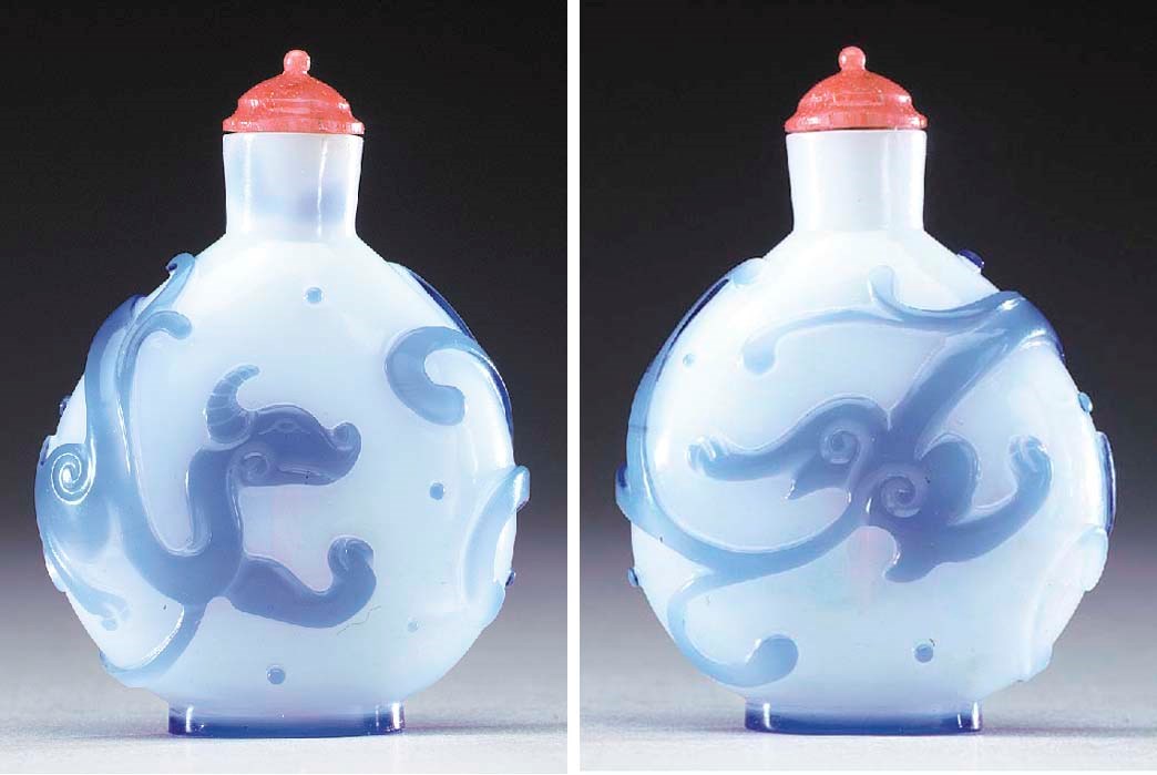 A VERY RARE AND FINELY CARVED BLUE OVERLAY WHITE GLASS BOTTLE
