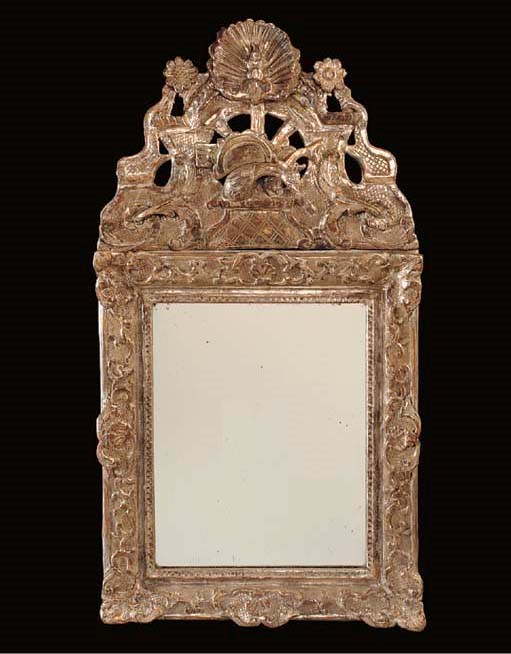 A REGENCE CARVED AND SILVERED MIRROR