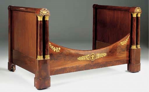 A FRENCH EMPIRE MAHOGANY AND ORMOLU MOUNTED LIT EN BATEAU