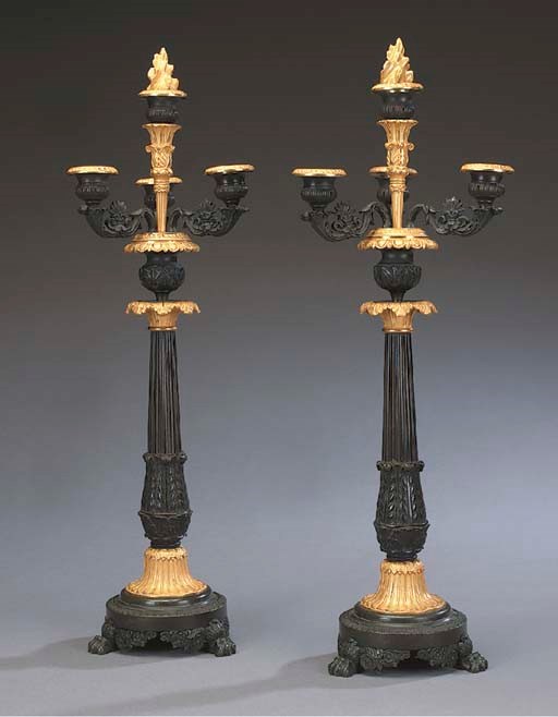 A pair of Louis Philippe gilt and patinated bronze four light candelabra, second quarter 19th century