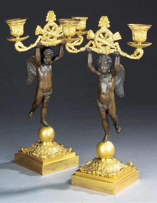 A pair of Charles X gilt and patinated bronze twin light candelabra