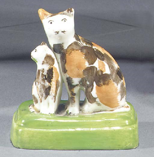 A porcelain group of a cat and kitten