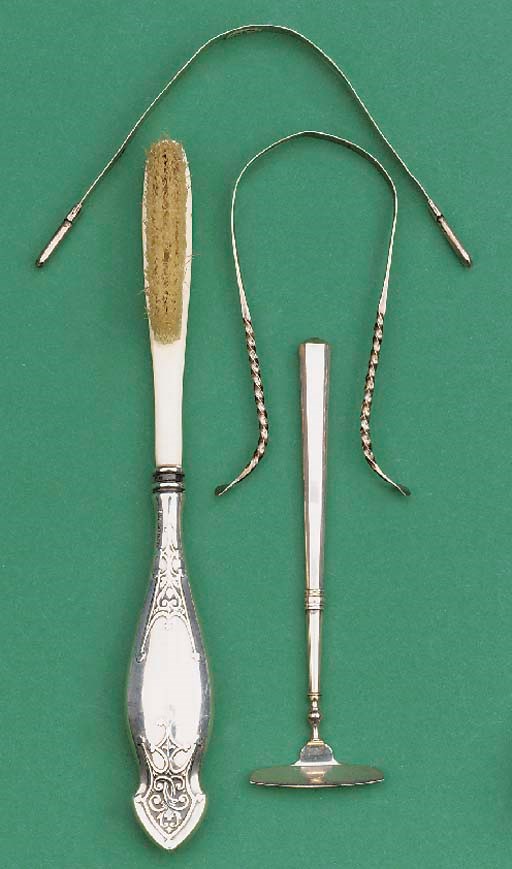 Three silver tongue-scrapers and a ivory tooth-brush,