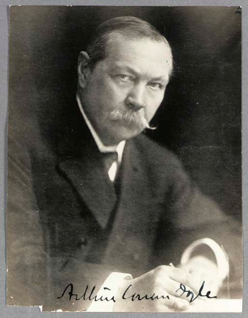 DOYLE, Arthur Conan, Sir. Photograph signed ("Arthur Conan Doyle"). N.p., n.d. 94 x 123 mm, tiny chip to lower corner, two green specks. A half-length portrait of Doyle seated at a table, writing. Provenance: Lee Keedick, New York (ink stamp on verso). Lee Keedick was Conan Doyle's agent for his 1922 lecture tour of America.