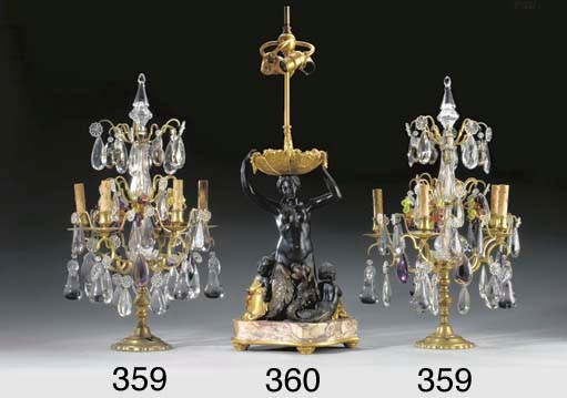 A pair of gilt-metal, clear and coloured cut glass six-light girandoles
