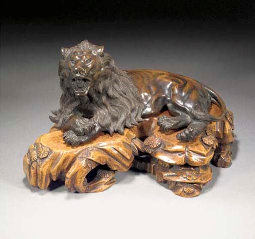 A Japanese patinated bronze model of a recumbent lion
19th century