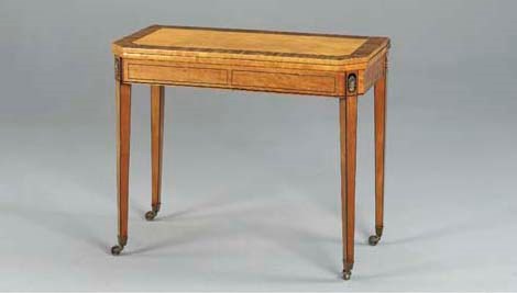 A REGENCY ORMOLU-MOUNTED SATINWOOD, CALAMANDER AND EBONY-INLAID GAMES TABLE,