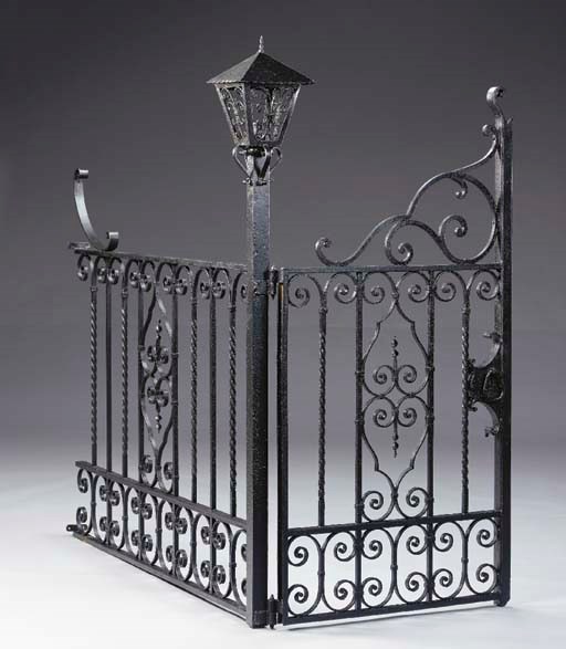 A BLACK-PAINTED WROUGHT-IRON GARDEN FENCE,