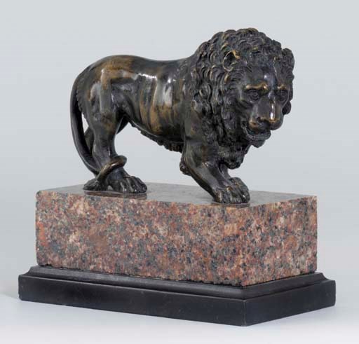 A BRONZE MODEL OF A PACING LION