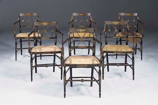 A set of six Regency ebonised and parcel gilt caned dining armchairs