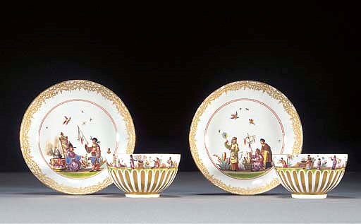 A pair of Meissen chinoiserie gilt gadrooned teabowls and saucers