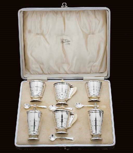 A GEORGE V CASED SILVER CONDIMENT SET,