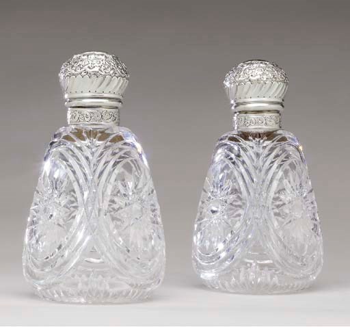 A PAIR OF CUT GLASS DECANTERS WITH SILVER MOUNTS,