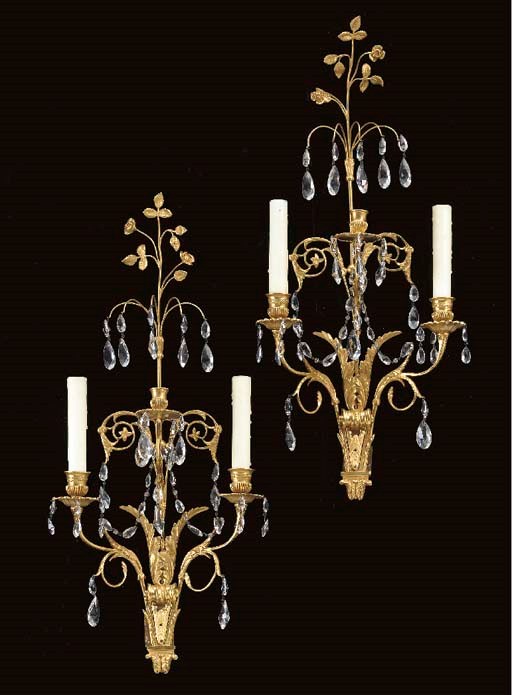 A PAIR OF NORTH EUROPEAN NEOCLASSIC STYLE ORMOLU AND CUT-GLASS THREE-BRANCH WALL-LIGHTS,