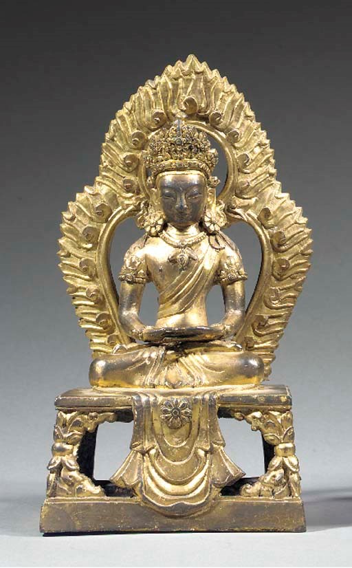 A GILT BRONZE MODEL OF A SEATED DEITY
18TH CENTURY