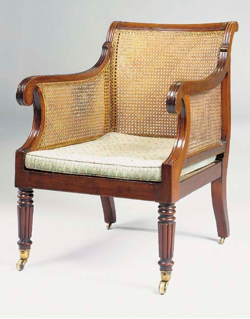 AN EARLY VICTORIAN MAHOGANY CANED LIBRARY BERGERE