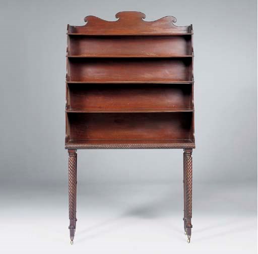 AN IRISH REGENCY MAHOGANY OPEN BOOKCASE-ON-STAND