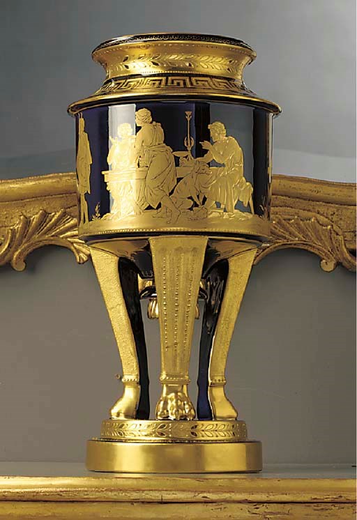 A late Hutschenreuter porcelain gilt dark blue-ground tripod neoclassical mythological vase and cover