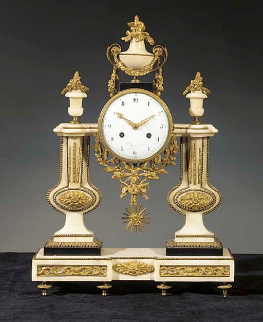 A Louis XVI ormolu-mounted black and white marble striking mantel clock