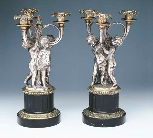 A PAIR OF NAPOLEON III SILVERED BRONZE AND BLACK MARBLE THREE LIGHT CANDELABRA