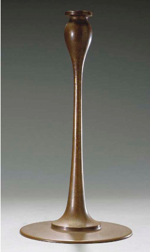 A BRONZE 'IOTA' CANDLESTICK