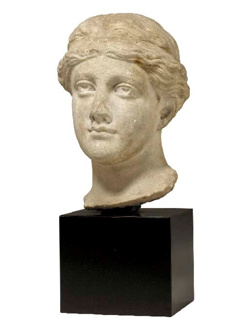 A ROMAN STYLE MARBLE HEAD OF A GODDESS,