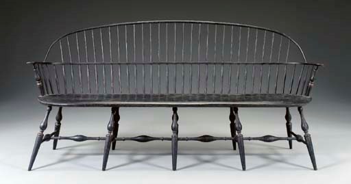A BLACK-PAINTED BOW-BACK WINDSOR STYLE SETTEE
