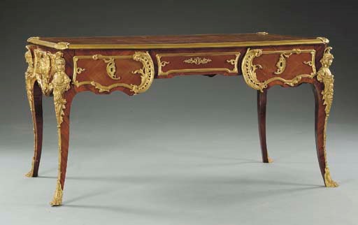 A Regence style ormolu-mounted kingwood and mahogany bureau plat