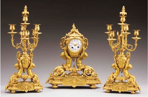 A Louis XVI style ormolu three-piece clock garniture