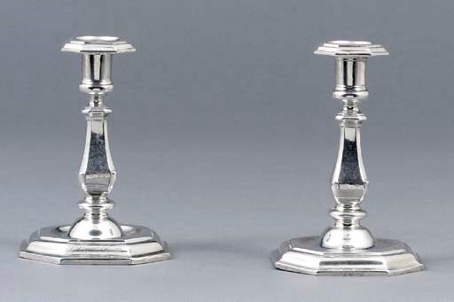 Two similar German silver candlesticks