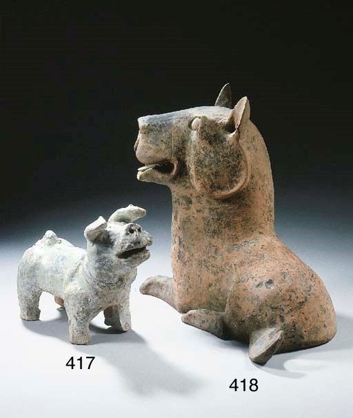 A green-glazed pottery figure of a dog