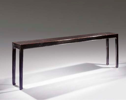 A narrow black lacquered side table