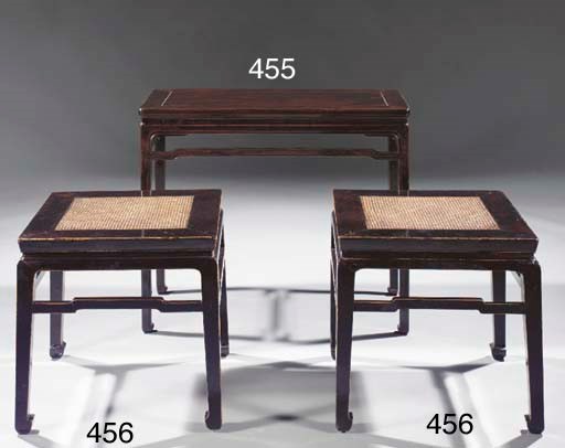 A pair of black lacquered square stools