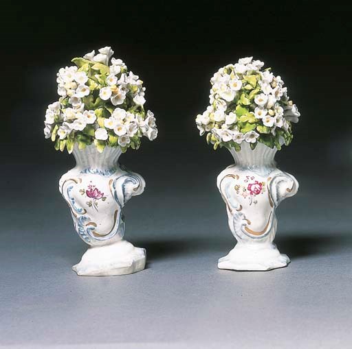 Two Derby rococo scroll-moulded vases of blossom