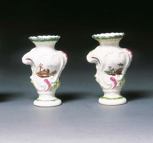 A pair of Derby rococo scroll-moulded base