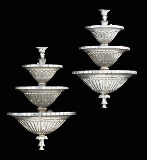 A PAIR OF SILVERED-METAL THREE TIERED SCONCES,