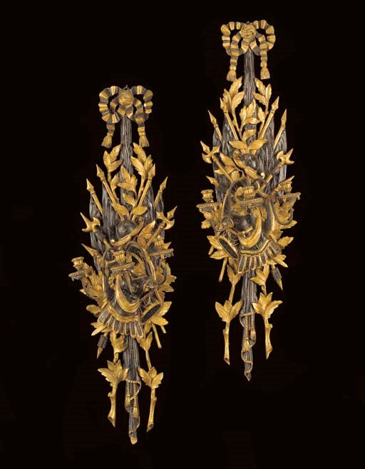 A PAIR OF ITALIAN NEOCLASSIC STYLE BLACK-PAINTED AND PARCEL-GILT THREE-BRANCH WALL-LIGHTS,