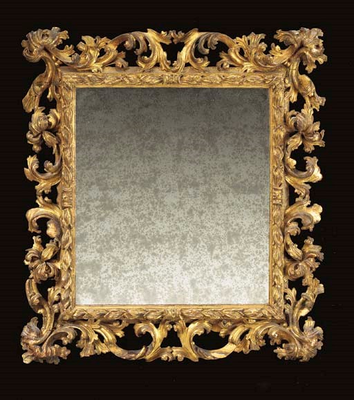 AN ITALIAN BAROQUE GILTWOOD MIRROR,