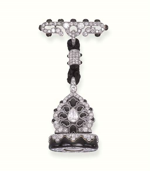 AN ART DECO DIAMOND, ONYX AND ENAMEL LAPEL WATCH