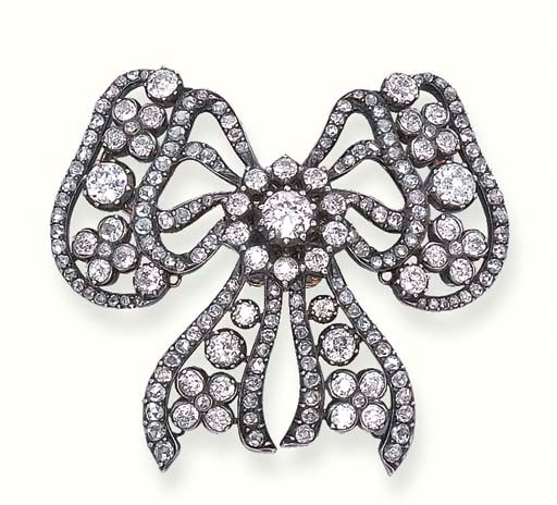AN ANTIQUE DIAMOND BOW BROOCH, BY CARTIER