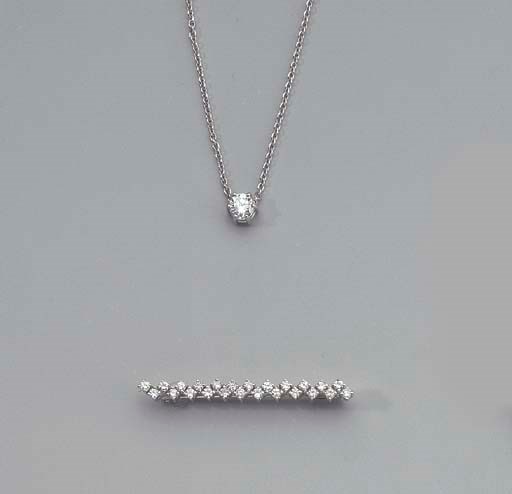A DIAMOND PENDANT AND BROOCH