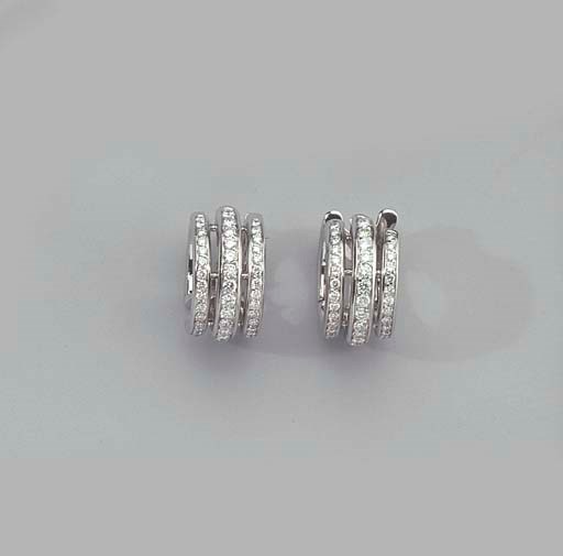 A PAIR OF WHITE GOLD AND DIAMOND EAR HOOPS AND A RING
