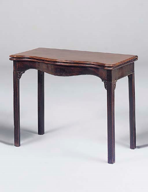 A George III mahogany serpentine tea table